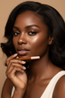 Gorgeous model holding product near face